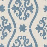 Detail of wallpaper in a damask stripe print in blue on a cream field.