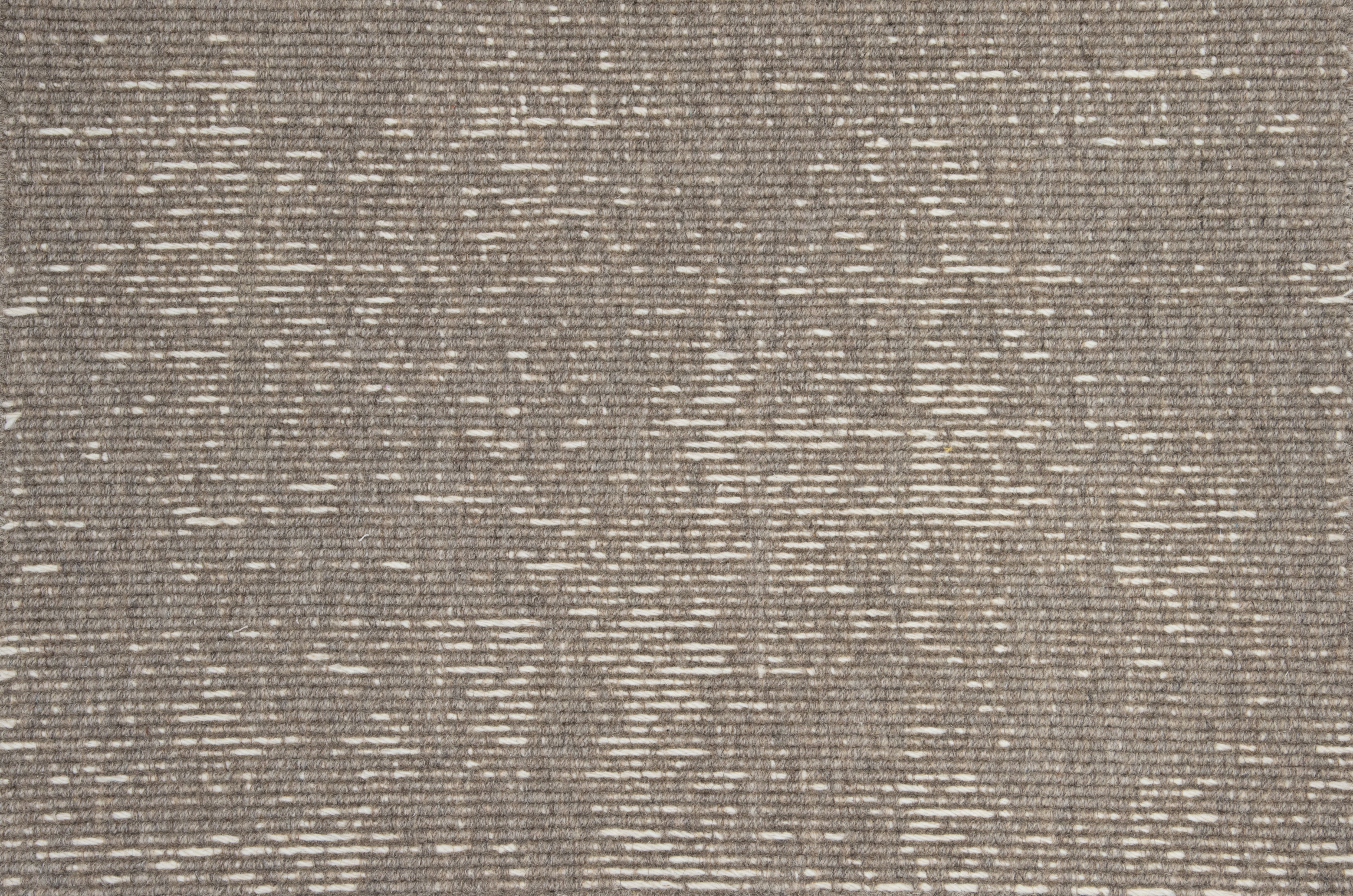 Broadloom carpet with ribbed stripe in brown. 