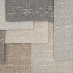 Layered samples of broadloom carpet in neutral colors. 