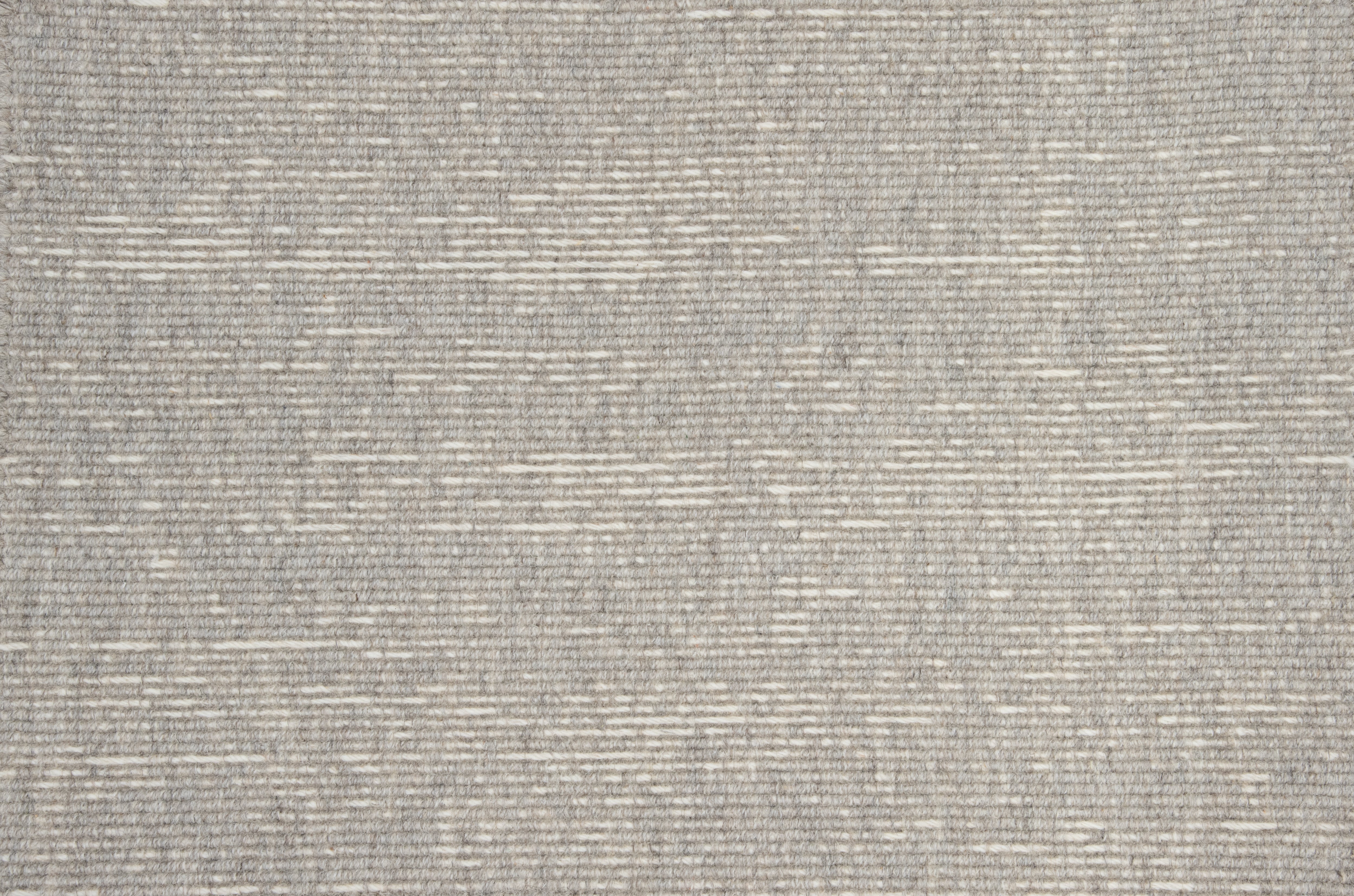 Broadloom carpet with ribbed stripe in grey.