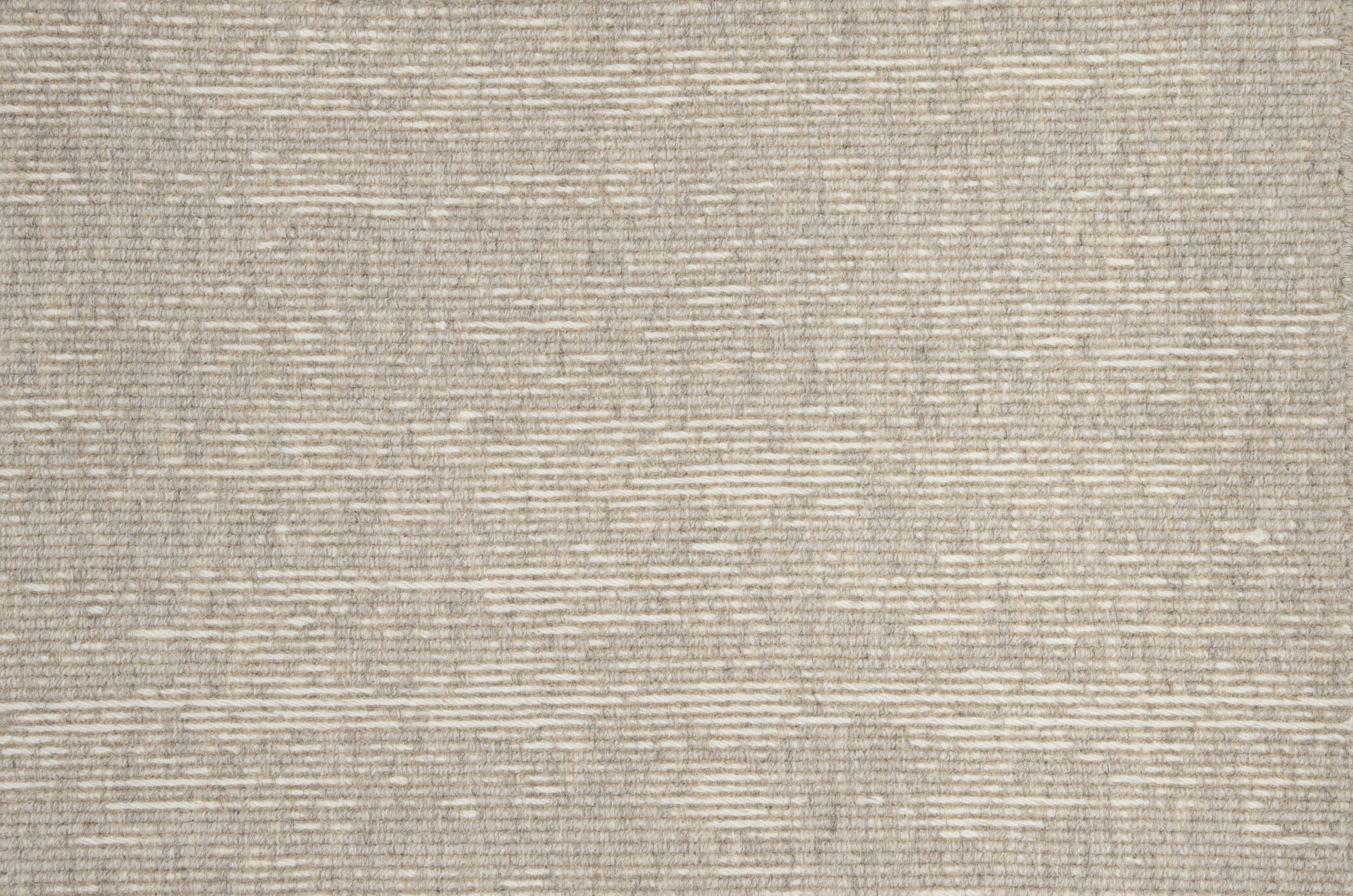 Broadloom carpet with ribbed stripe in beige.
