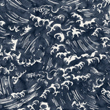 Detail of wallpaper in a playful wave print in white on a navy watercolor field.