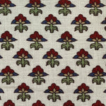 Pattern of stylized flowers with red centers and green leaves on a white background