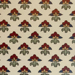 Patterned fabric with red, green, and blue floral design on a beige background