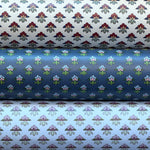 Three wallpaper rolls with dainy floral patterns. 