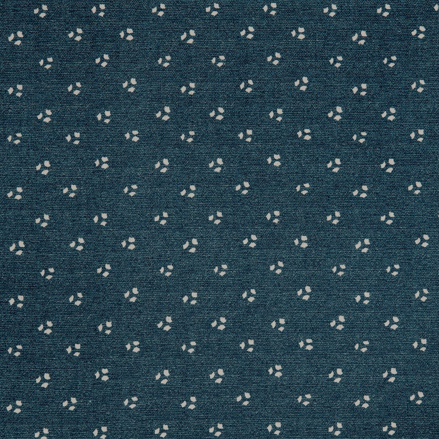 Detail of a linen fabric in a clustered dot pattern in cream on an indigo field.