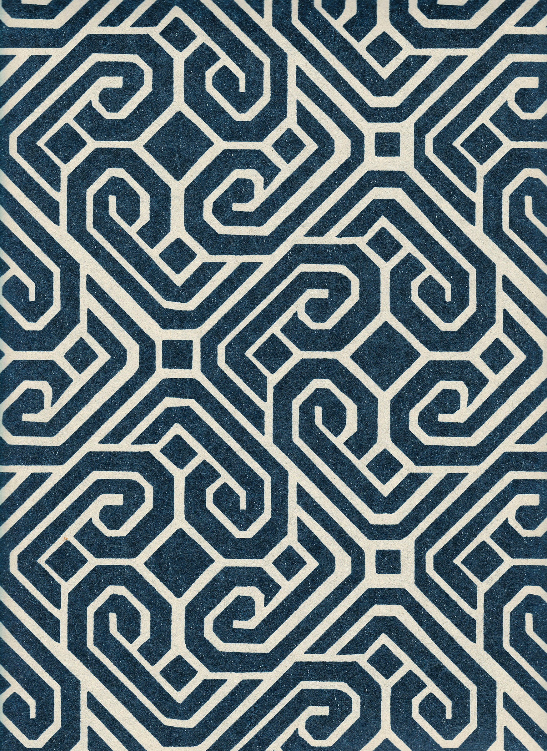 Detail of wallpaper in a geometric lattice print in navy on a cream field.