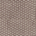 Fabric in a repeating abstract print in maroon on a tan field.