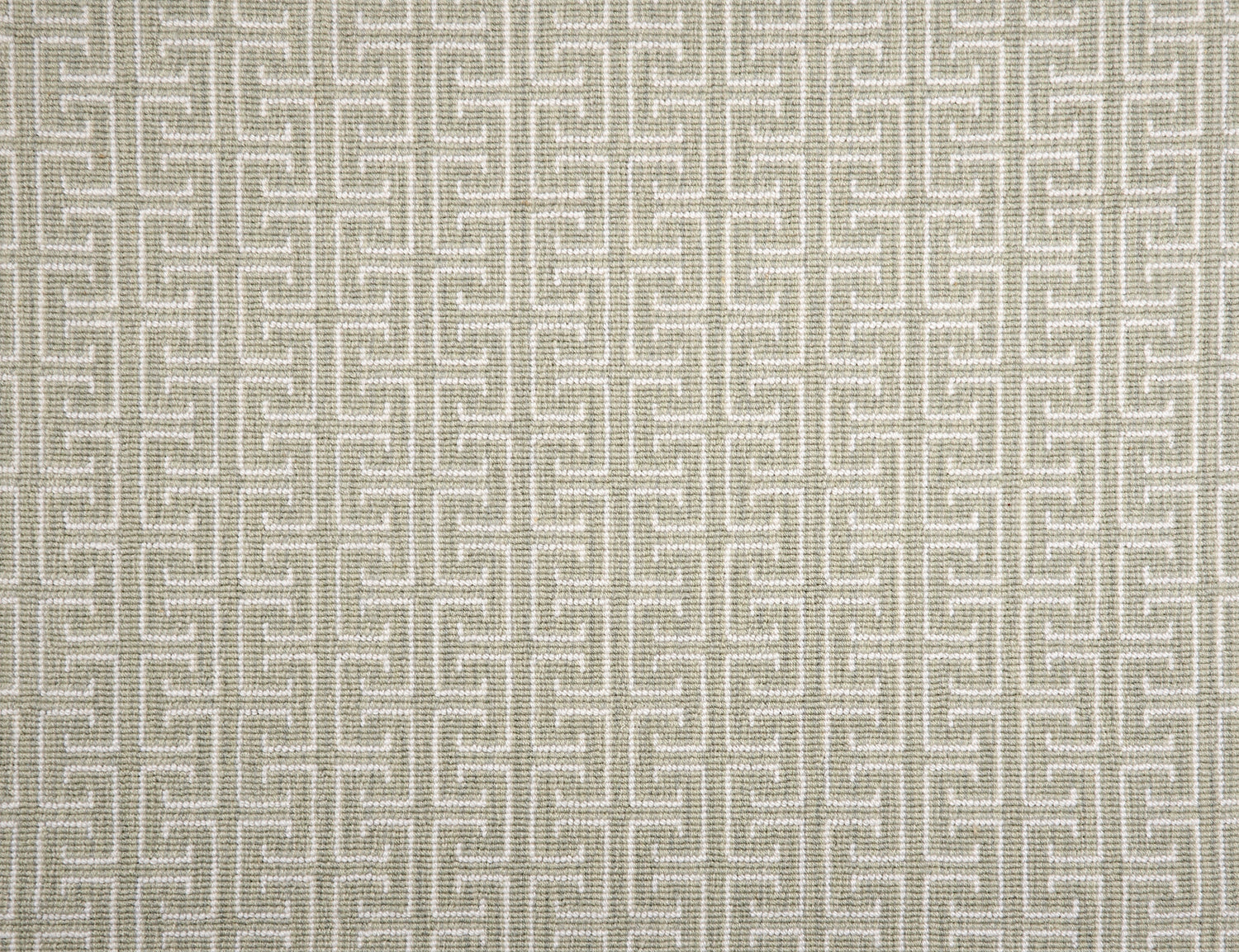 Broadloom carpet with geometric Greek pattern in ivory on sage green.