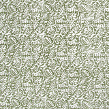 Detail of fabric in a dense paisley print in white on a mottled green field.