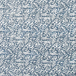 Detail of fabric in a dense paisley print in white on a mottled navy field.