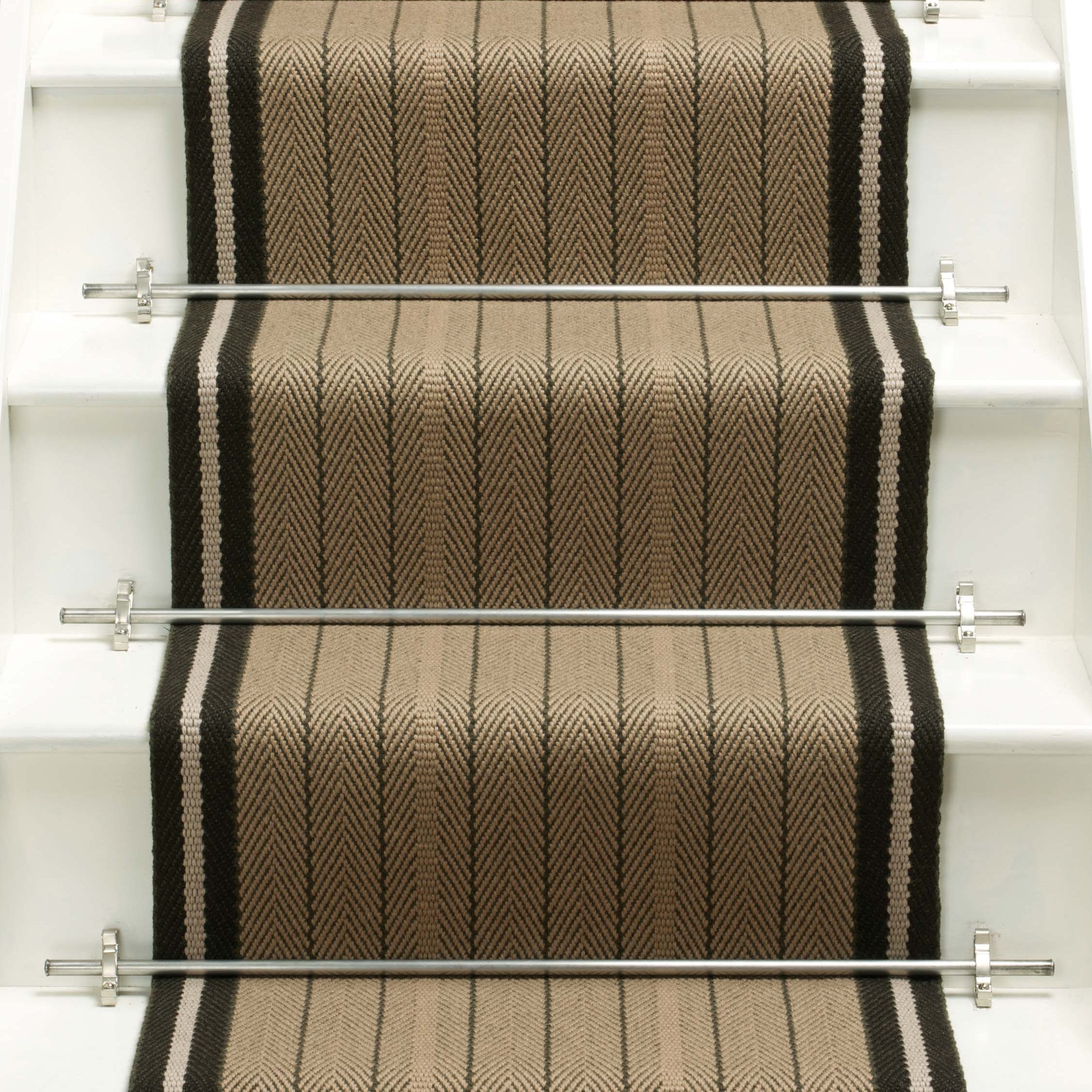 Striped flatweave runner in tan and black on white staircase