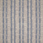Detail of fabric in a dense tribal stripe pattern in shades of blue and beige.