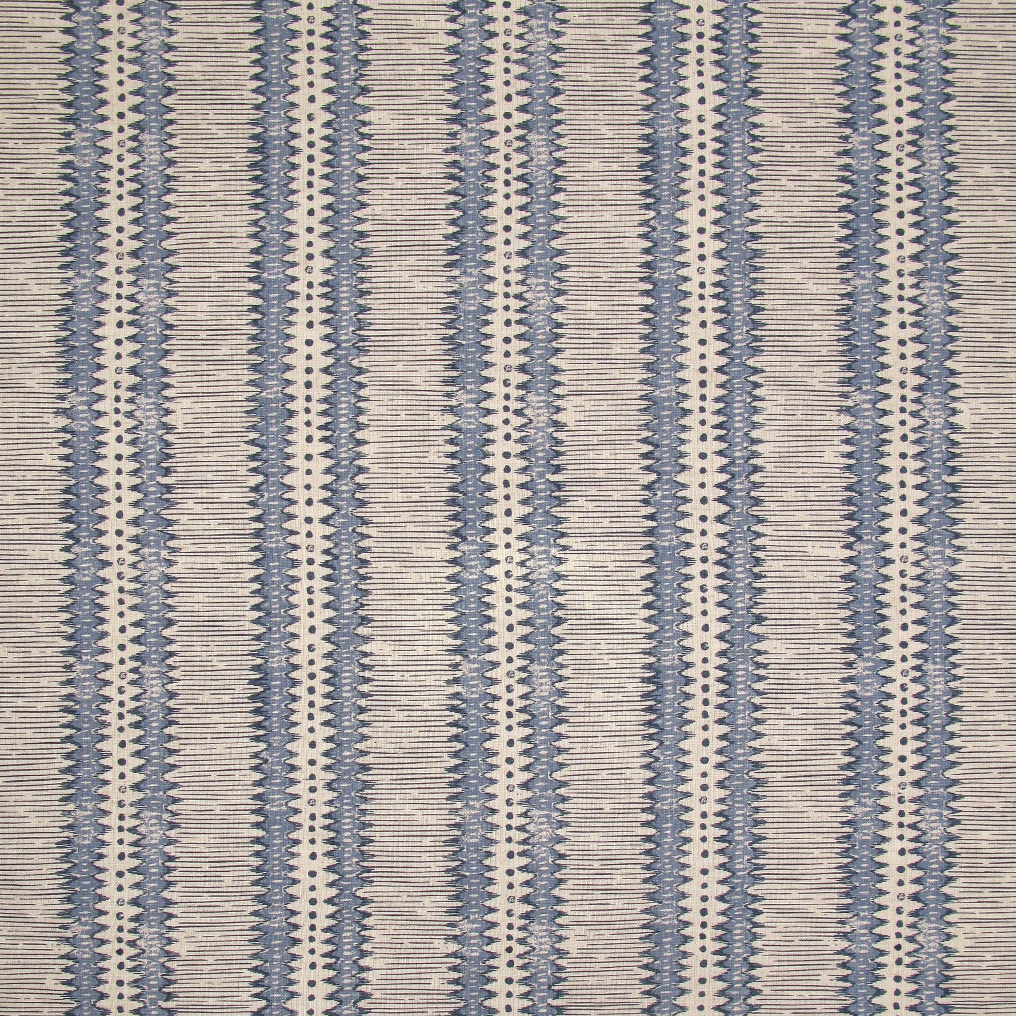 Detail of fabric in a dense tribal stripe pattern in shades of blue and beige.