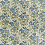 Printed linen in a hand drawn daisy design in shades of blue with green leaves on a pale cream field.