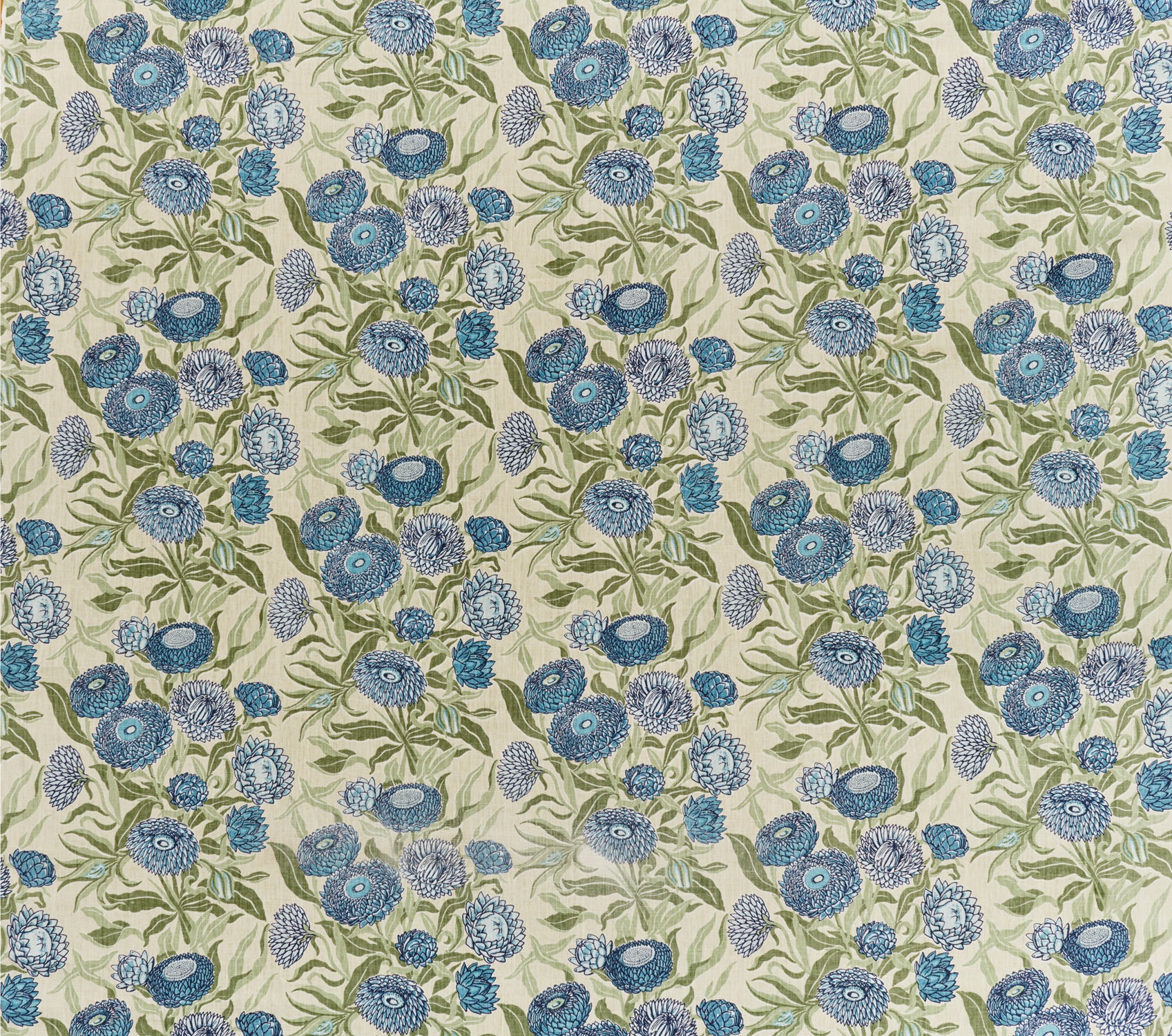 Printed linen in a hand drawn daisy design in shades of blue with green leaves on a pale cream field.