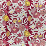 Printed linen in a hand drawn daisy design in shades of red, pink and yellow with sage leaves on a crimson field.