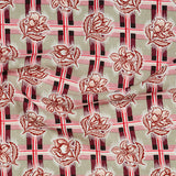 Draped fabric in a repeating floral print in shades of blue and white on a green grid print.