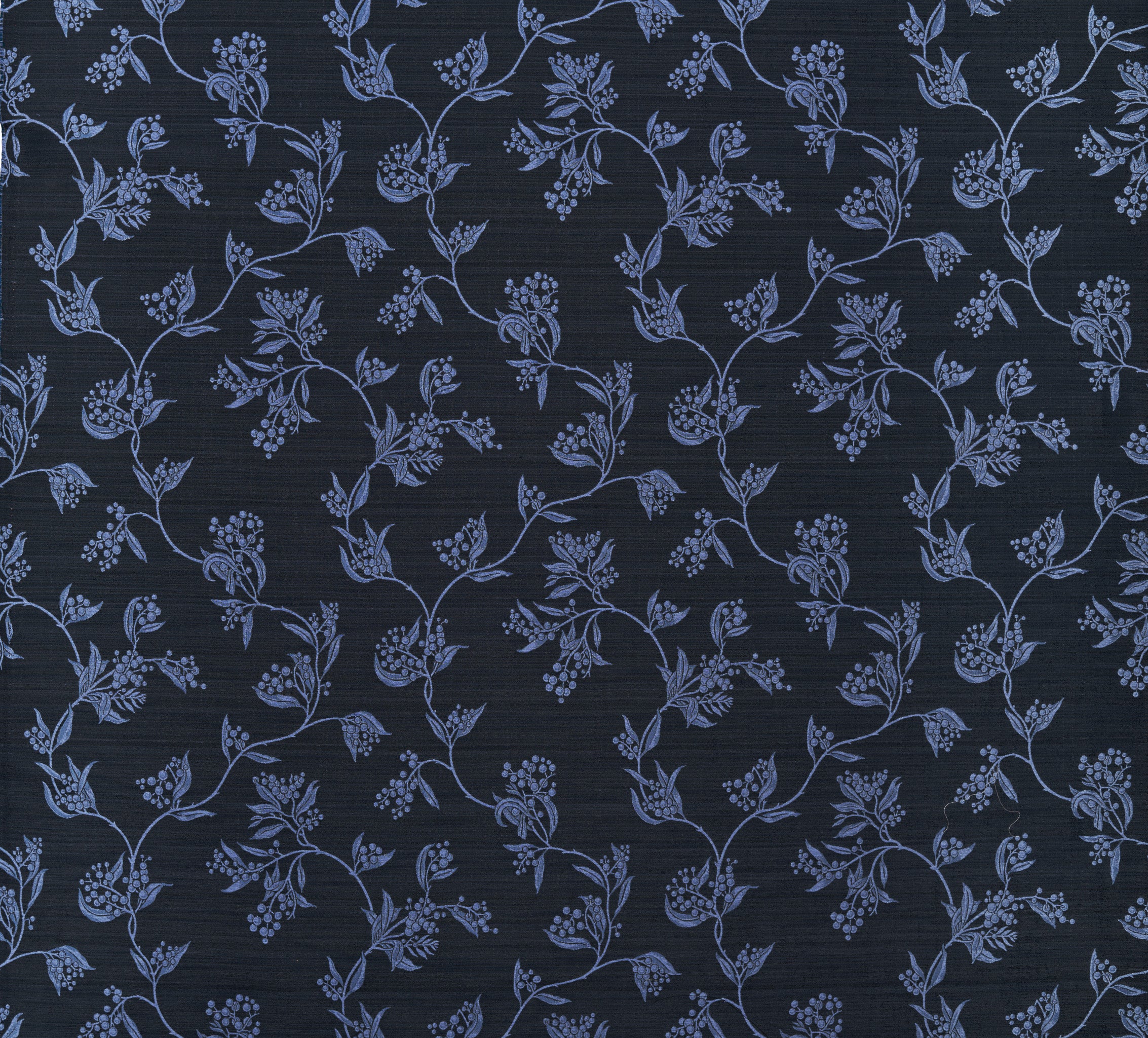 Performance fabric with a scrolling floral design in navy blue. 