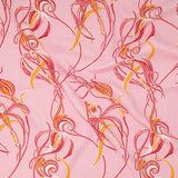 Draped fabric in a posy print in turquoise and white on a gray field.