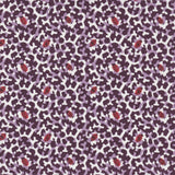 Detail of fabric in a playful irregular botanical print in red and purple on a white field.