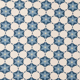 Woven fabric in a floral lattice print in blue and navy on a cream field.