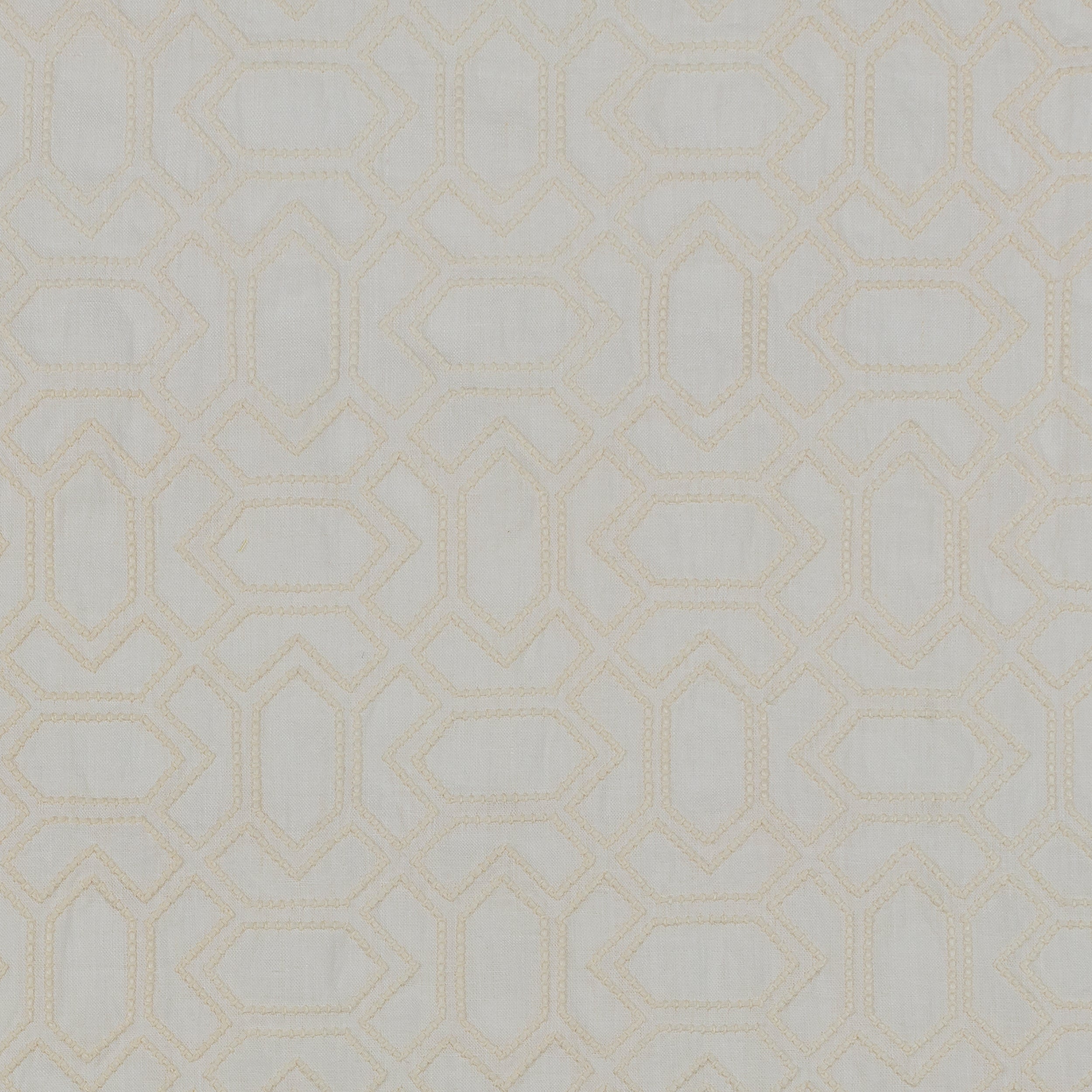 Fabric with an embroidered geometric grid print in cream on a light gray field.