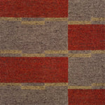 Detail of a handwoven carpet in a geometric design in brown, red with yellow accent. 