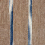 Detail of fabric in an irregular stripe print in navy and orange on a cream field.