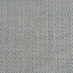 Close up of a rug in a woven herringbone pattern in grey-blue.