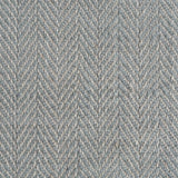 Close up of a rug in a woven herringbone pattern in grey-blue.