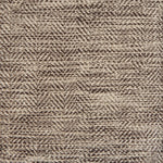 Close up of a rug in a woven herringbone pattern in shades of brown.