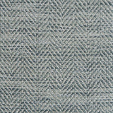 Close up of a rug in a woven herringbone pattern in shades of blue.