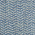 Close up of a rug in a woven herringbone pattern in blue.