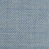 Close up of a rug in a woven herringbone pattern in blue.