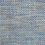 Close up of a rug in a woven herringbone pattern in blues.