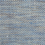 Close up of a rug in a woven herringbone pattern in blues.