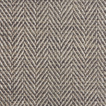Close up of a rug in a woven herringbone pattern in grey and brown.