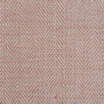 Close up of a rug in a woven herringbone pattern in light pink