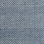 Close up of a rug in a woven herringbone pattern in blue.
