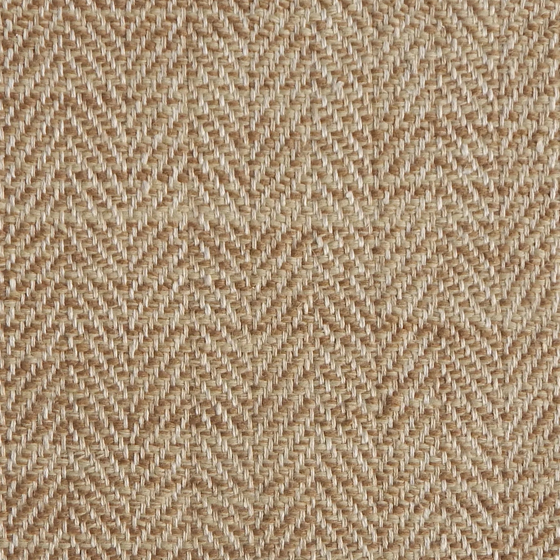 Close up of a rug in a woven herringbone pattern in tan.