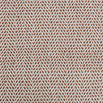 A handwoven rug with a herringbone weave in white with striated yarns of brown, rust orange and pale blue. 