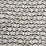 A handwoven rug with a herringbone weave in white with striated yarns of tan and marine blue. 