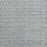 A handwoven rug with a herringbone weave in white with striated yarns of dark grey and marine blue.