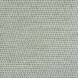 A handwoven rug with a herringbone weave in white with striated yarns in shades of light green.