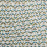 A handwoven rug with a herringbone weave in white with striated yarns of green and turquoise.