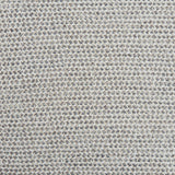 A handwoven rug with a herringbone weave in white with striated yarns in shades of grey.