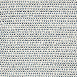 A handwoven rug with a herringbone weave in white with striated yarns of grey and blue.