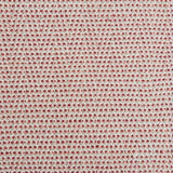 A handwoven rug with a herringbone weave in white with striated yarns of pink and red.