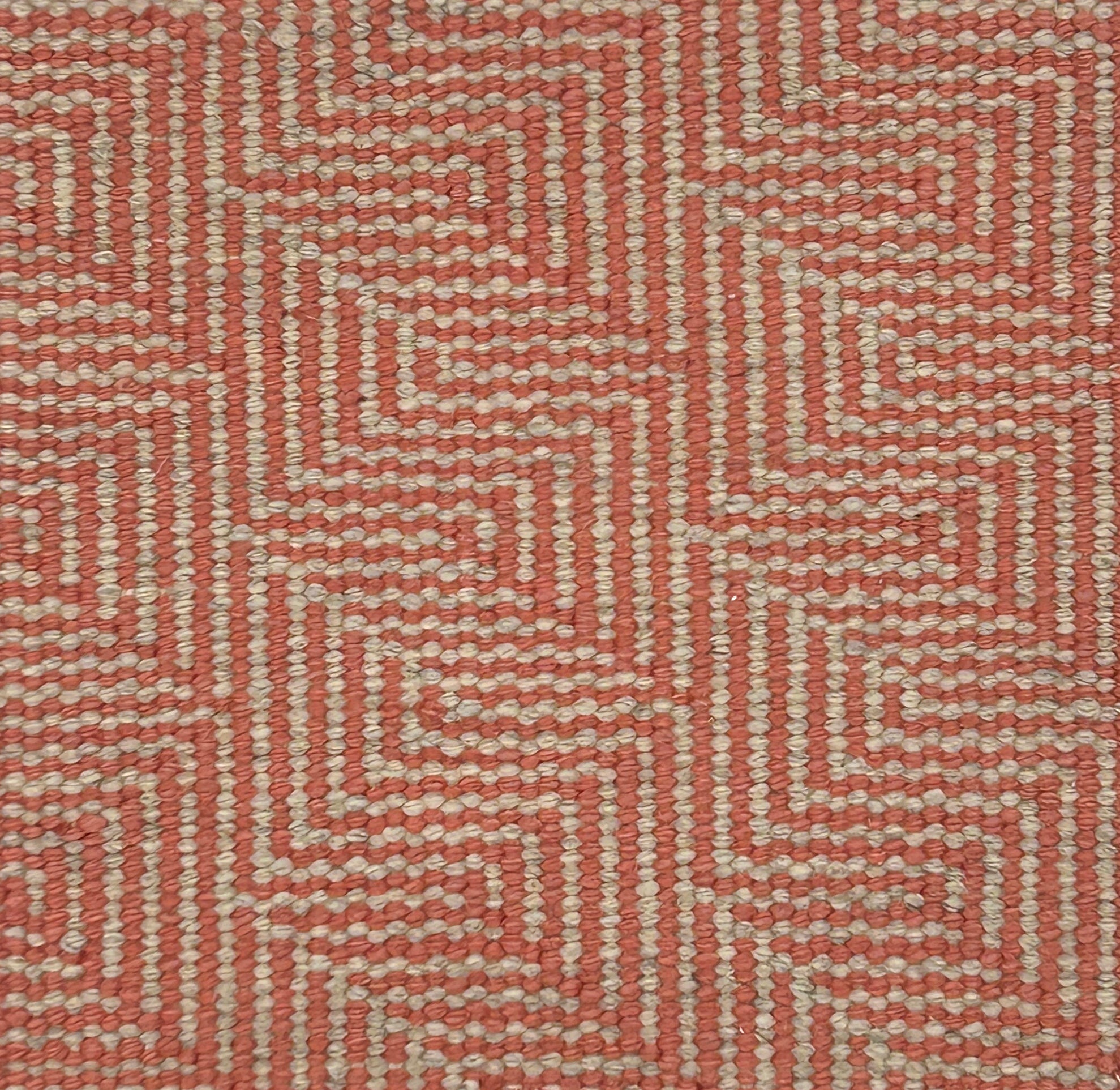 Flatweave rug with a zig zag herringbone weave in taupe and coral. 